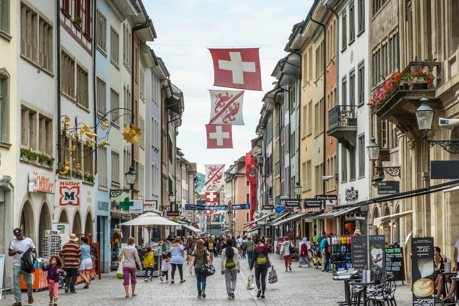 Pagal Šveicarijos vėliavas pėstiesiems eina užimta Marktgasse link Winterthur miesto miesto centro, Šveicarijos