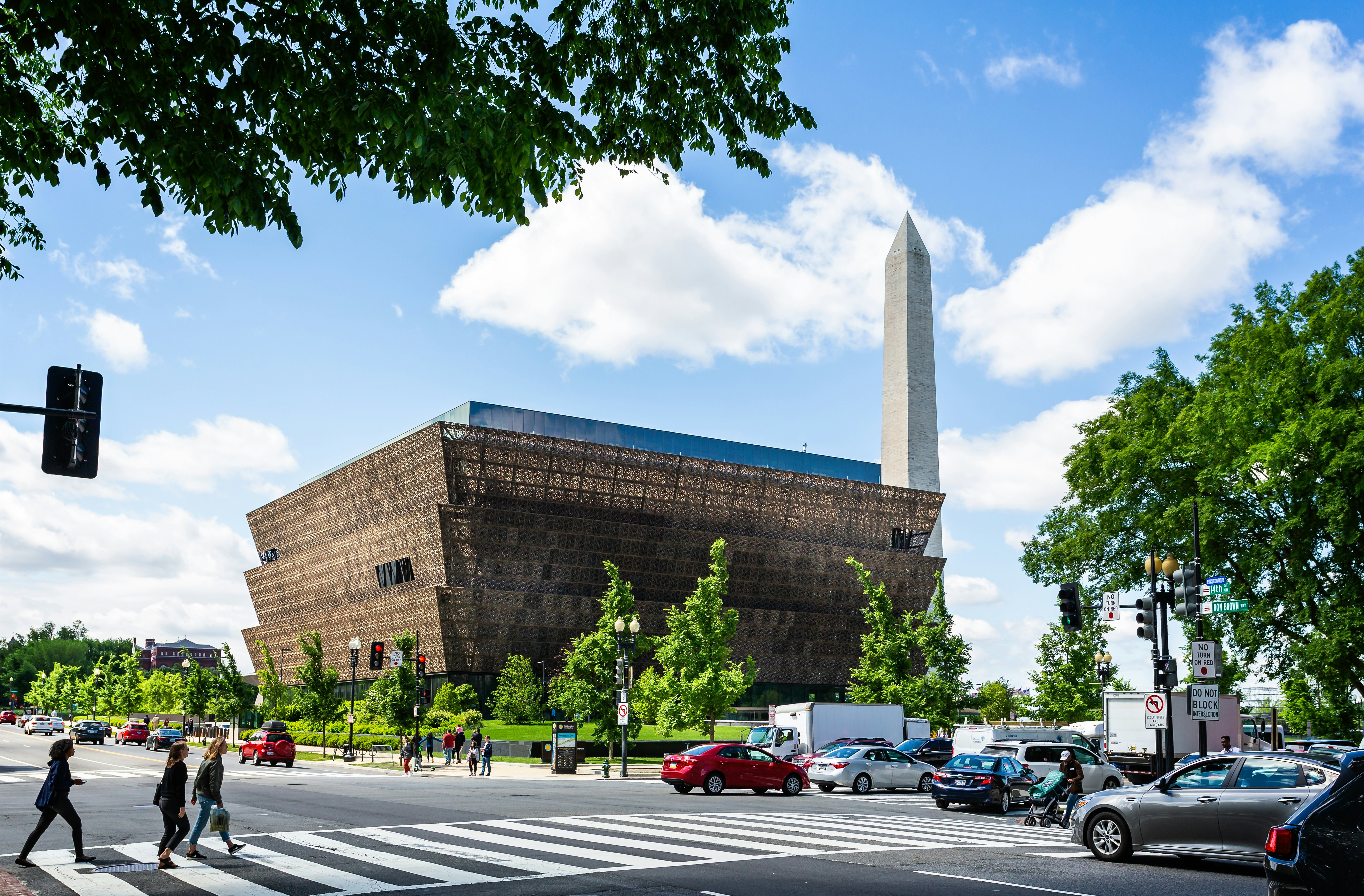 Exterior of a large museum building with people passing by