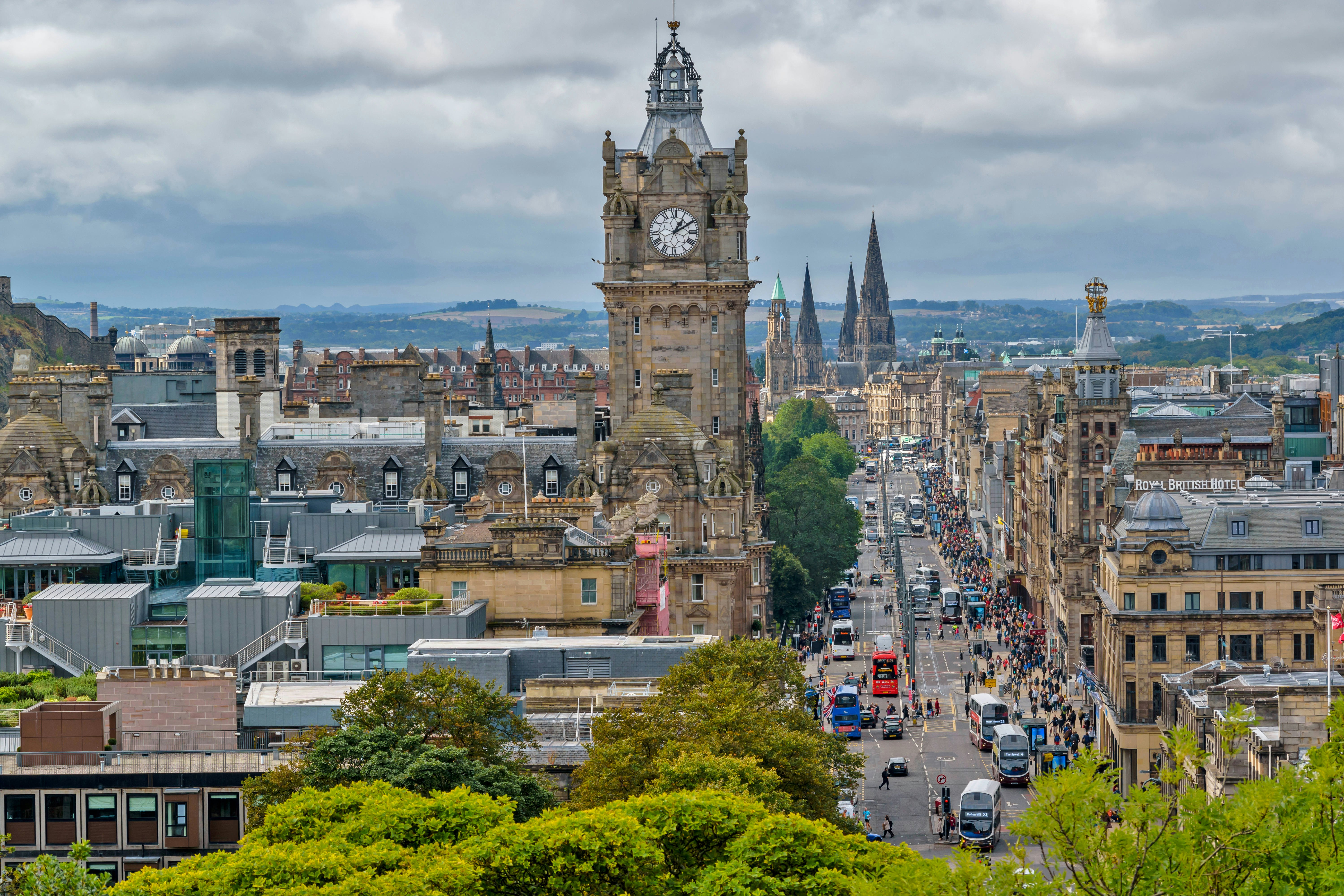 A busy city street lined with double-decker buses and other traffic