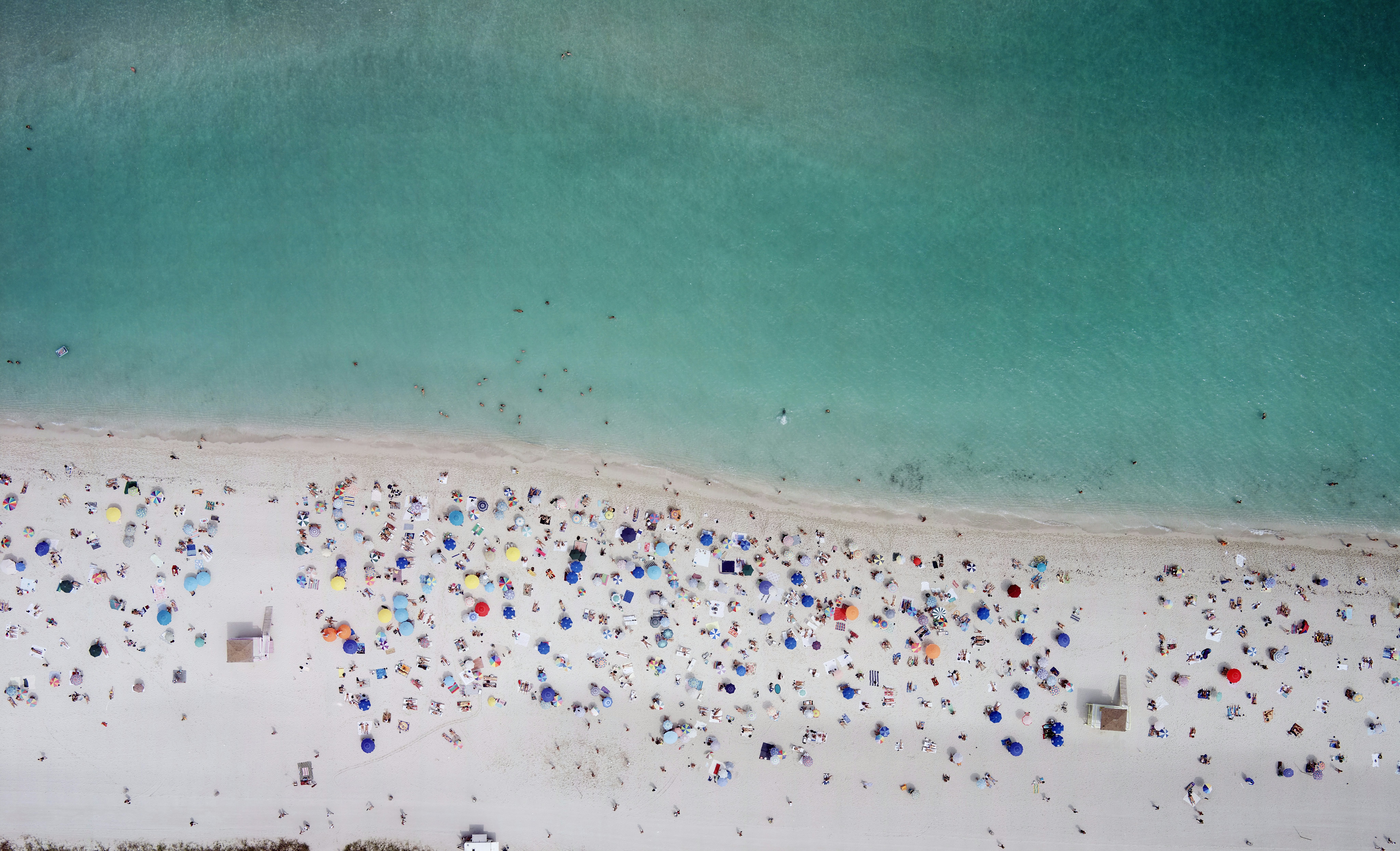 Aerial of a crowded day at Miami beach. Enjoyment Vacations Travel Destinations Horizontal Outdoors Aerial View Tourist USA Water's Edge Sand Day Sea Beach Florida - US State Miami Beach Color Image Incidental People Leisure Activity Photography Tourism Relaxation Haulover Gulf Coast States AutotagHighlyAuthentic - Do Not Delete