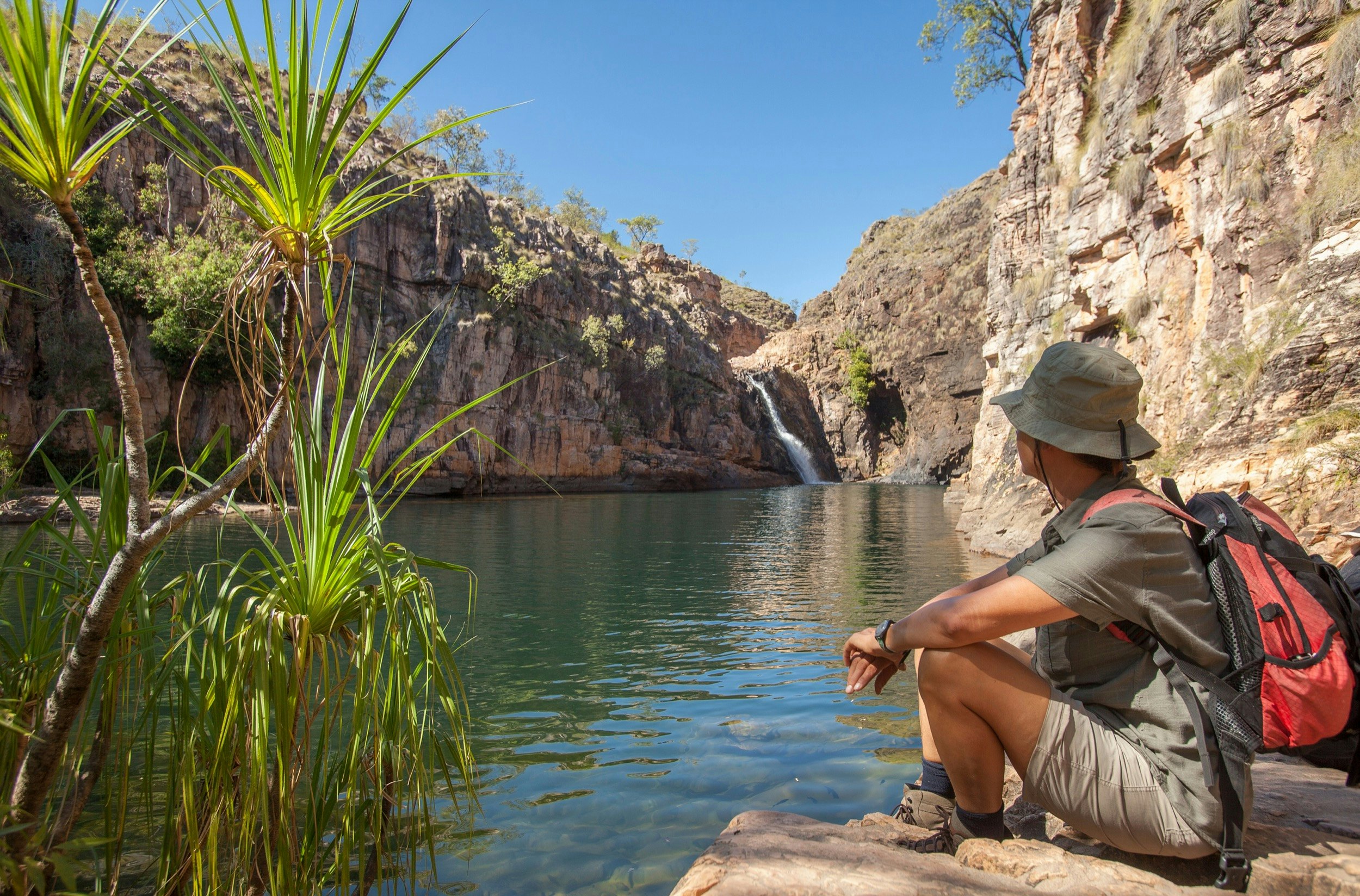 Man overlooks Rock pool at the Barramundi falls, Kakadu National Park, one of the crocodile-free lakes in this area