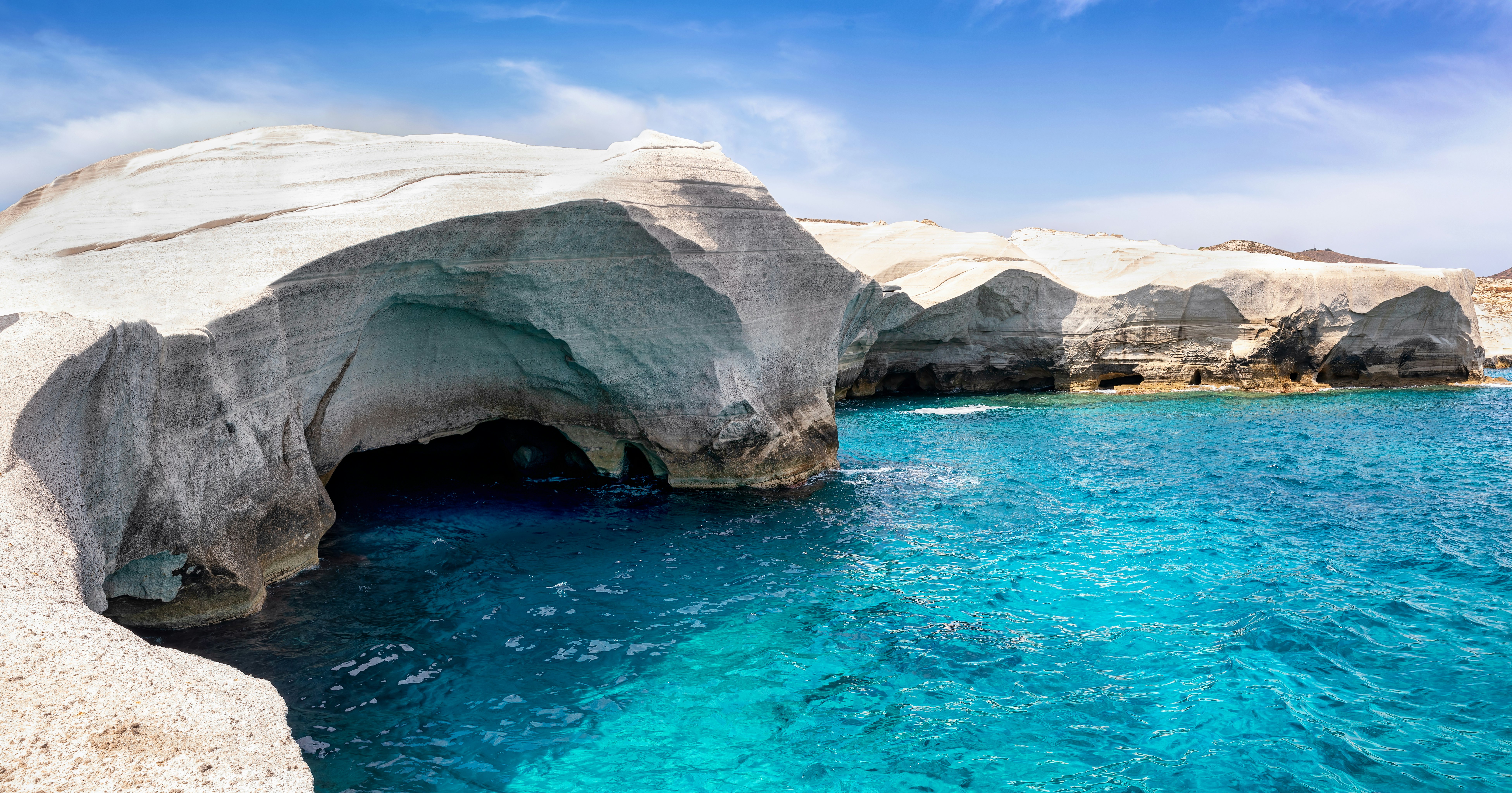 View to the lunar rock formations of the famous Sarakiniko beach on the cycladic island of Milos, Greece, with turquoise sea and moonscape coastline