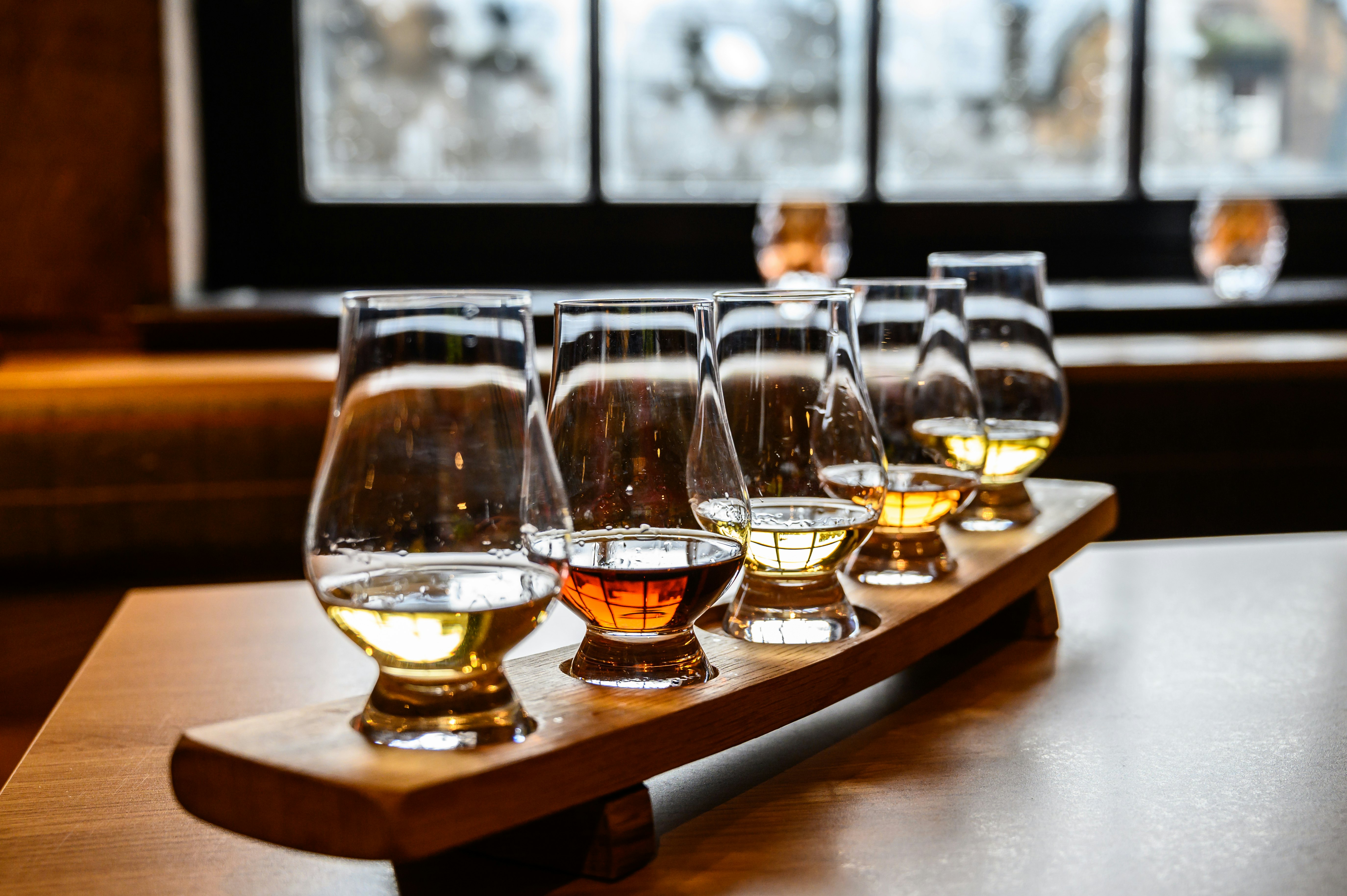 Glasses of Scotch whisky ready to sample at a distillery tour in Scotland.