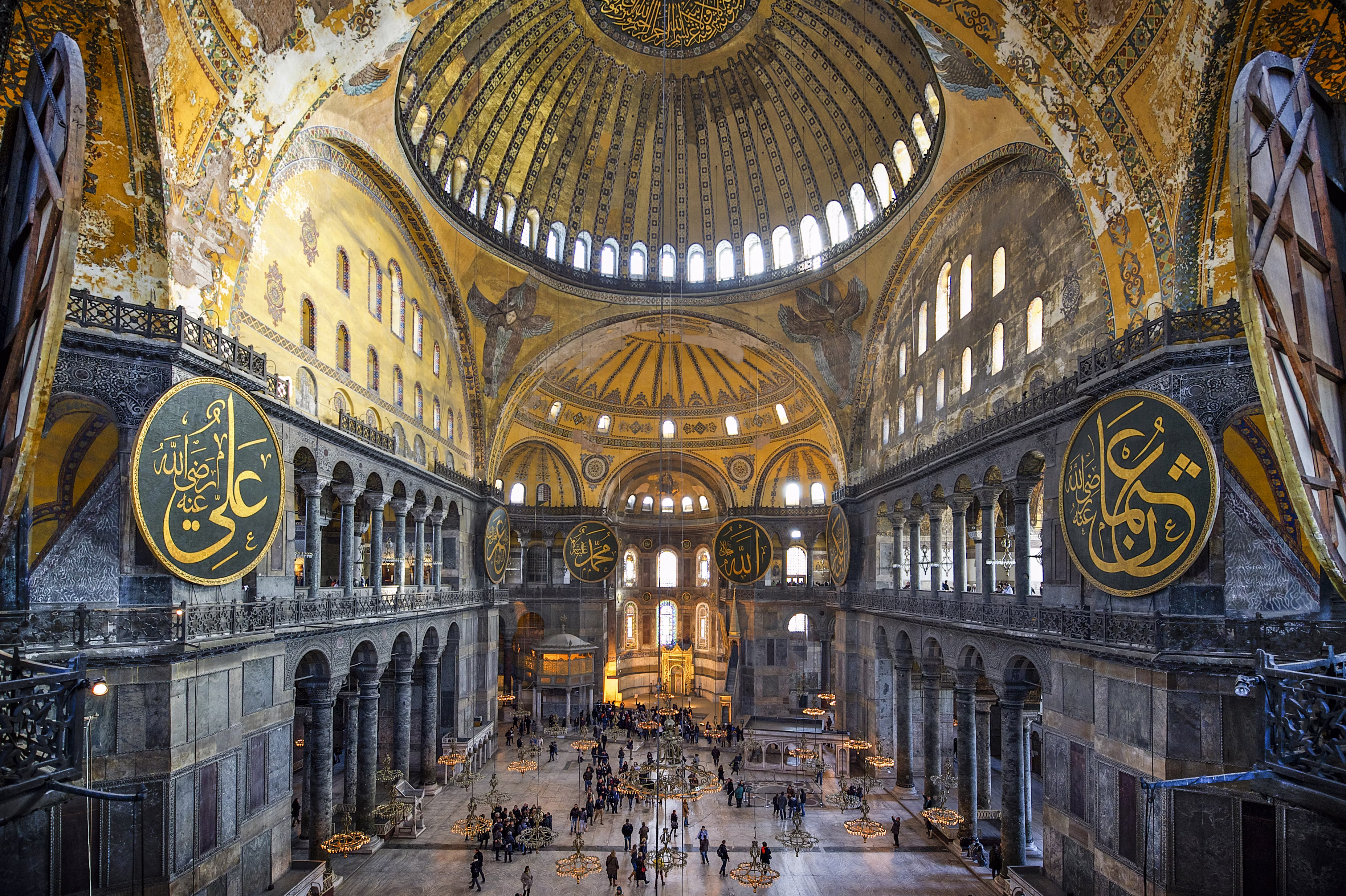 A view from above an ornately decorated interior, with gold accents and a dramatic dome.